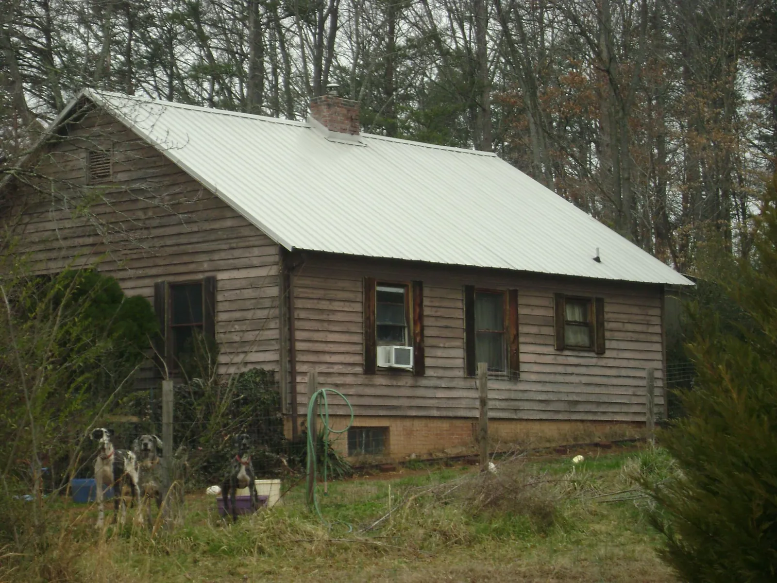 White metal roof on an old wood sided farmhouse, from a Metal Roof Installation job in Saint Maries
